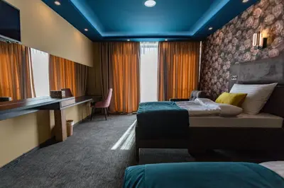 a hotel room with two beds and a desk at HOTEL LOBBY in Bihać