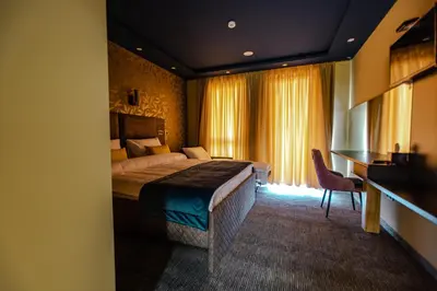 a hotel room with a bed and a desk at HOTEL LOBBY in Bihać