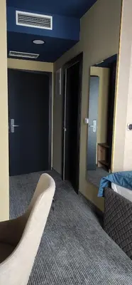 an empty room with a bed and a mirror at HOTEL LOBBY in Bihać