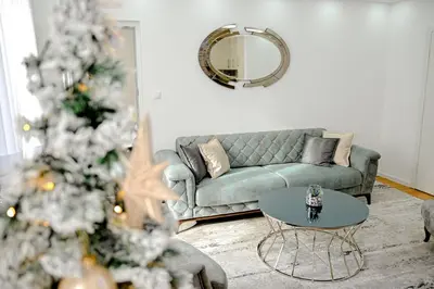 a living room with a christmas tree and a couch at Fontana apartmani FREE parking in Tuzla