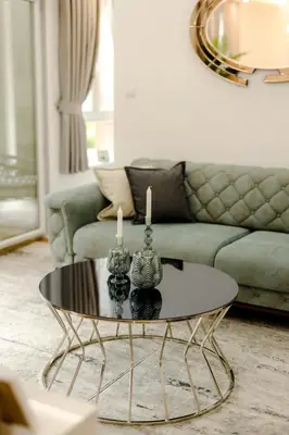 a living room with a table with two candles on it at Fontana apartmani FREE parking in Tuzla