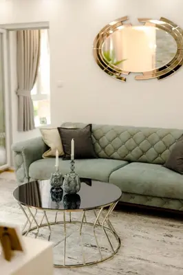 a living room with a couch and a table at Fontana apartmani FREE parking in Tuzla