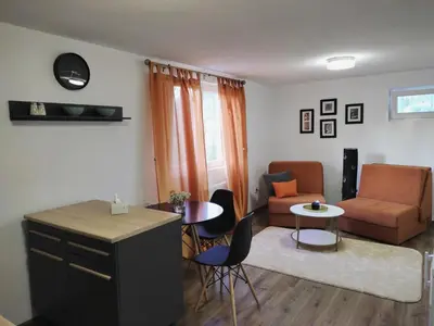 a living room with a couch and a table and chairs at Dream Home Studio Apartments in Tuzla