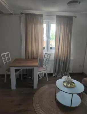 a living room with a table and a table and chairs at Dream Home Studio Apartments in Tuzla