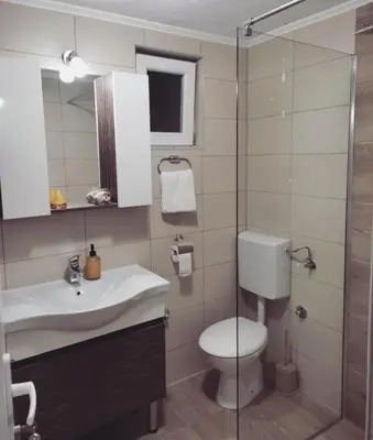 a bathroom with a toilet and a sink and a shower at Dream Home Studio Apartments in Tuzla