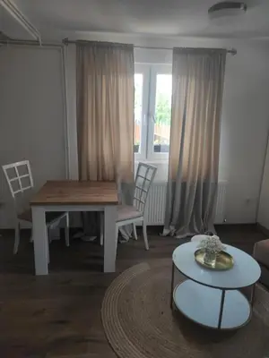 a living room with a table and a table and chairs at Dream Home Studio Apartments in Tuzla