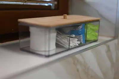 a glass shelf with a toilet paper dispenser on it at Sobe - Rooms Drvorez in Banja Luka