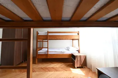 a bunk bed in a room with a wooden ceiling at Sobe - Rooms Drvorez in Banja Luka