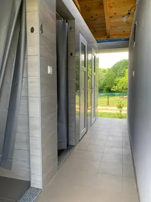 an empty hallway of a building with a door at Kuća za odmor KRNJAIĆ,porodični KAMP in Bosanski Novi