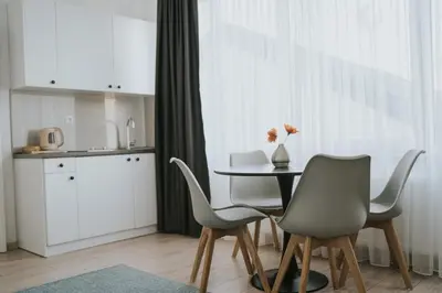 a kitchen and dining room with a table and chairs at Hotel Central Vlašić in Vlasic