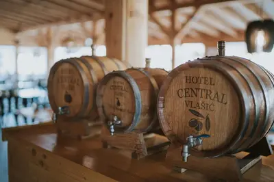a row of wine barrels sitting on top of a table at Hotel Central Vlašić in Vlasic
