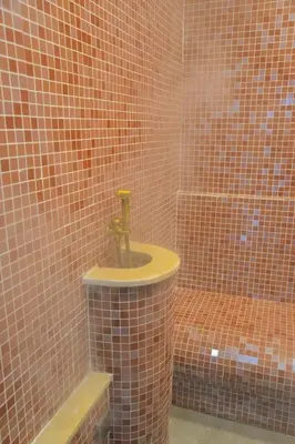 a tiled bathroom with a sink and a toilet at Hotel Central Vlašić in Vlasic