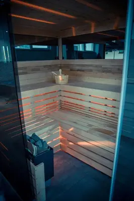 a wooden sauna with a light shining on it at Hotel Central Vlašić in Vlasic