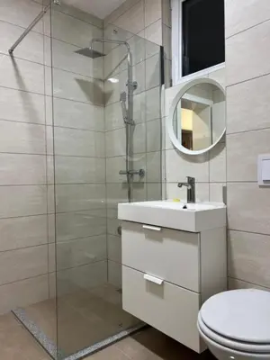 a bathroom with a shower and a toilet and a sink at Hotel Central Vlašić in Vlasic