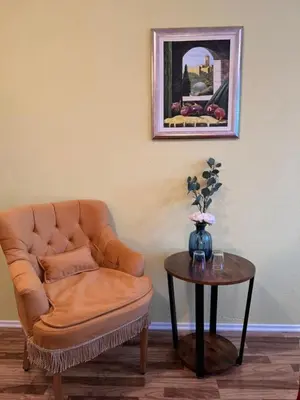 a living room with a chair and a table at Hotel Central Vlašić in Vlasic