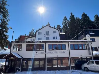 a large white building with the sun above it at Hotel Central Vlašić in Vlasic