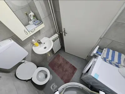 a small bathroom with a toilet and a sink at Apartman u centru Prnjavor in Prnjavor