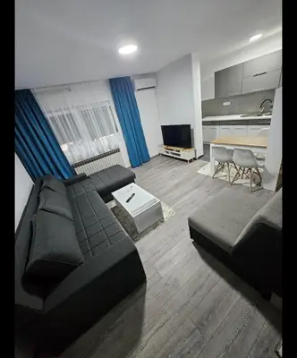 a living room with a couch and a table at Apartman u centru Prnjavor in Prnjavor