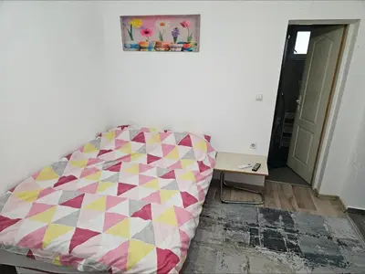 a couch sitting in a living room next to a table at Apartman u centru Prnjavor in Prnjavor