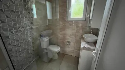 a small bathroom with a toilet and a sink at City apartment 3 in Visoko