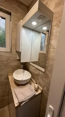 a bathroom with a sink and a mirror at City apartment 3 in Visoko
