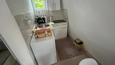 a small kitchen with a sink and a refrigerator at City apartment 3 in Visoko