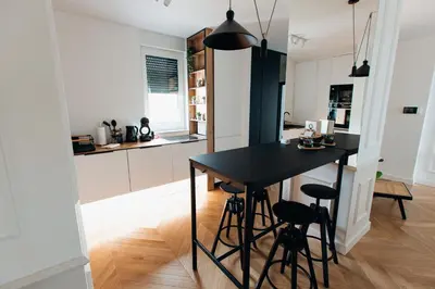 a kitchen with a black table and stools at Stan na dan - Chic Home Banja Luka in Banja Luka
