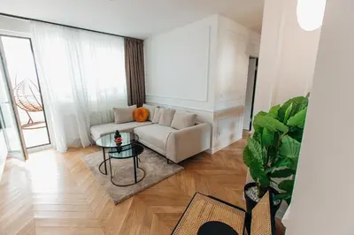 a living room with a couch and a table at Stan na dan - Chic Home Banja Luka in Banja Luka