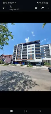 a large apartment building in front of a parking lot at Stan na dan - Chic Home Banja Luka in Banja Luka