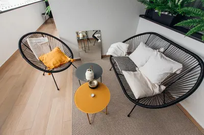 a room with two chairs and a table with a couch at Stan na dan - Chic Home Banja Luka in Banja Luka