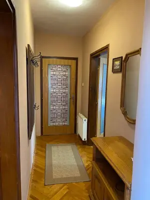 a room with a bathroom with a door and a mirror at Apartman Lavanda in Drvar