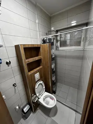 a small bathroom with a toilet in a stall at Apartmani Venci Travnik in Travnik