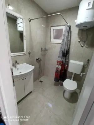 a bathroom with a toilet and a sink at Apartmani Kula in Tuzla