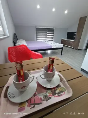 a coffee table with two cups on top of it at Apartmani Kula in Tuzla