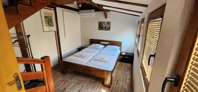a small bedroom with a bed with blue sheets at Holiday home LOTUS in Bihać