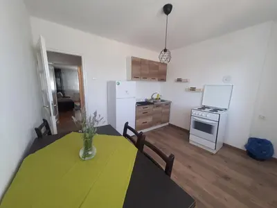a kitchen with a table with a yellow table cloth on it at Apartman Nataša BL in Banja Luka