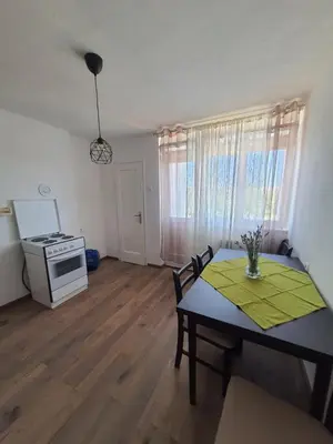 a living room with a table and a stove at Apartman Nataša BL in Banja Luka