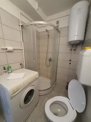 a small bathroom with a toilet and a shower at Apartman Nataša BL in Banja Luka