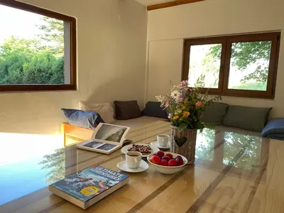 a living room with a table with a laptop and fruit on it at Mountain Heart House in Bosanski Petrovac