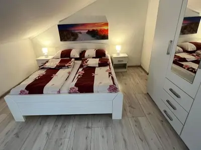 a bedroom with a bed and two night stands at Stan Centar 1 in Banja Luka