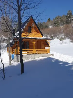 a log cabin with snow on the ground at Planinska brvnara in Kupres