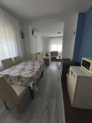 a living room with a table and a couch at Šadrvan Una Apartment in Bihać