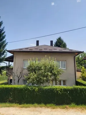 a house with a hedge in front of it at Šadrvan Una Apartment in Bihać
