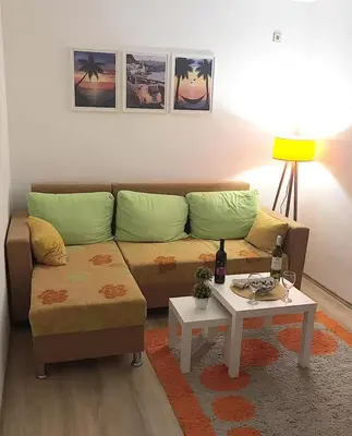 a living room with a couch and a table at Apartman Dunja II in Prijedor