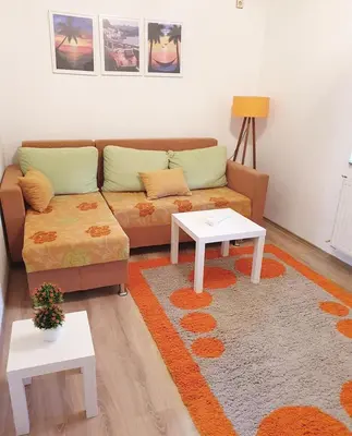 a living room with a couch and a table at Apartman Dunja II in Prijedor