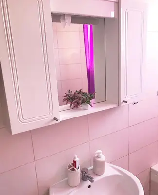 a bathroom with a sink and a mirror at Apartman Dunja II in Prijedor