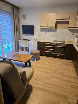 a kitchen with a couch and a table in a room at Urban Home Visoko in Visoko