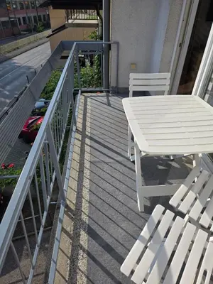 a white table and chairs on a balcony with a table at Urban Home Visoko in Visoko