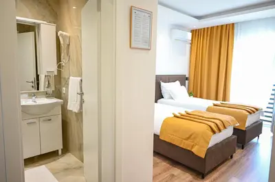 a hotel room with two beds and a sink at Hotel Premium in Jajce