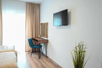 a hotel room with a desk and a bed at Hotel Premium in Jajce